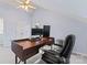 A well-lit office space with a wooden desk, ergonomic chair, and modern computer setup with neutral walls at 1921 Kenilworth Ave, Charlotte, NC 28203