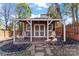 Charming shed with a covered porch, cozy seating, and a well-maintained exterior. Includes string lights at 1921 Kenilworth Ave, Charlotte, NC 28203