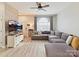 Comfortable living room showcasing a large sectional sofa, wood-look flooring, and natural light from large window at 1923 Gables Dr, Monroe, NC 28112