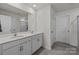 Bright bathroom with double vanity, white cabinets, and a large mirror at 2112 Eastway Dr, Dallas, NC 28034