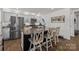 Modern kitchen island with granite countertops, stainless steel appliances, and stylish wooden bar stools at 2112 Eastway Dr, Dallas, NC 28034