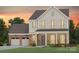 Charming two-story home featuring stone accents, a two-car garage, and manicured landscaping at 2229 Millennium Dr # 014, Lancaster, SC 29720