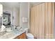 Bathroom with large mirror, glass bowl sink, and tile floor at 241 Queens Rd, Charlotte, NC 28204