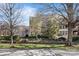 Elegant brick building with lush landscaping and a welcoming entrance, showcasing classic architecture and curb appeal at 241 Queens Rd, Charlotte, NC 28204