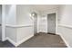 Hallway with neutral walls, carpeted floor, decorative doors, and sconces, blending functionality with style at 241 Queens Rd, Charlotte, NC 28204