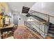 Stylish hallway featuring a staircase with iron railing, accented by a patterned rug, and hardwood floors at 241 Queens Rd, Charlotte, NC 28204