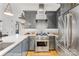 Modern kitchen with stainless steel appliances, gray cabinetry and marble countertops at 241 Queens Rd, Charlotte, NC 28204