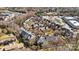 Drone shot of the red brick townhome community surrounded by shopping and parking at 243 Crownsgate Ct, Charlotte, NC 28207