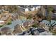 Aerial view of townhome community with parking, a creek and mature landscaping at 243 Crownsgate Ct, Charlotte, NC 28207