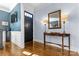 Welcoming foyer with hardwood floors, table lamps on a console table, and a black front door at 243 Crownsgate Ct, Charlotte, NC 28207