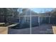 Rear exterior featuring a blue home with a well kept yard with new mulch and a paved patio area at 2721 Dora Dr, Charlotte, NC 28215