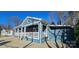 Charming blue home with a covered porch, white railings, and a well-manicured front yard at 2721 Dora Dr, Charlotte, NC 28215