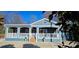 Inviting home featuring a cozy covered porch, white railings, and a charming facade at 2721 Dora Dr, Charlotte, NC 28215
