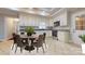 A gourmet kitchen and dining area features granite countertops, stainless steel appliances, and decorative tile floors at 2721 Dora Dr, Charlotte, NC 28215