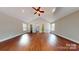 Expansive living room featuring hardwood floors, neutral paint, vaulted ceilings and many windows for light at 2721 Dora Dr, Charlotte, NC 28215