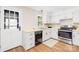 Well-lit kitchen features white cabinets, stainless steel appliances, and wood-look flooring at 2927 Forest Hills Cir, Rock Hill, SC 29732