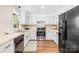 Well-lit kitchen features white cabinetry, stainless steel appliances, and wood-look flooring at 2927 Forest Hills Cir, Rock Hill, SC 29732