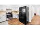 Bright kitchen features black refrigerator, stainless steel stove and white cabinetry at 2927 Forest Hills Cir, Rock Hill, SC 29732