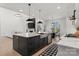 Open kitchen layout with an island, stainless steel appliances, and an adjacent dining area at 296 Riley Dr, Taylorsville, NC 28681