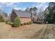 Spacious backyard featuring well-manicured landscaping, a brick exterior, and a cozy patio area at 2968 Robinwood Rd, Gastonia, NC 28054