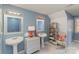 Stylish bathroom featuring dual pedestal sinks, decorative mirrors, and a charming wicker storage shelf at 2968 Robinwood Rd, Gastonia, NC 28054