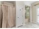 Bathroom featuring white tile flooring, a shower with curtain, and a separate tub at 2968 Robinwood Rd, Gastonia, NC 28054