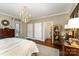 Spacious bedroom featuring hardwood floors, a decorative chandelier, and dual closets at 2968 Robinwood Rd, Gastonia, NC 28054