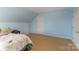 Bright bedroom with an angled ceiling, plush carpeting and soft lighting. A perfect place to relax at 2968 Robinwood Rd, Gastonia, NC 28054