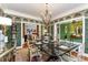 Formal dining room with elegant wallpaper, chandelier, and glass-top dining table at 2968 Robinwood Rd, Gastonia, NC 28054