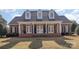Charming brick home featuring a welcoming front porch with columns and dormer windows at 2968 Robinwood Rd, Gastonia, NC 28054