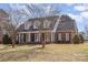 Charming brick home featuring a welcoming front porch with columns and dormer windows at 2968 Robinwood Rd, Gastonia, NC 28054