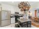 Charming kitchen featuring white cabinetry, stainless steel appliances, and a unique pot rack chandelier at 2968 Robinwood Rd, Gastonia, NC 28054