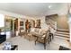 Bright and spacious living room with neutral tones, plush seating, and staircase at 2968 Robinwood Rd, Gastonia, NC 28054