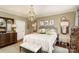 Spacious main bedroom with large windows, chandelier, and stylish decor creating a cozy retreat at 2968 Robinwood Rd, Gastonia, NC 28054