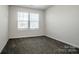 Bright bedroom with neutral carpet and a large window offering ample natural light at 3220 5Th Street Ne Ct, Hickory, NC 28601