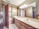 Bathroom with a double sink vanity, a shower, and a view of the door way at 3719 Amarillo Sw Dr, Concord, NC 28027