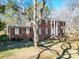 Elegant brick home with white columns, black shutters, and a well-manicured lawn at 3719 Amarillo Sw Dr, Concord, NC 28027