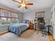 Cozy bedroom with a ceiling fan, comfortable bed, and a view of the outdoors at 3725 Plumgrove Ct, Charlotte, NC 28210