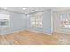 Bedroom with neutral walls, natural light, and wood-look flooring at 3726 Ernie Dr, Charlotte, NC 28269