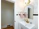 Charming bathroom with pink wallpaper, white tile, and a vintage-style mirror at 4310 Randolph Rd, Charlotte, NC 28211