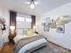 Comfortable bedroom featuring a cozy bed, wood floors, and a wall with framed art at 4310 Randolph Rd, Charlotte, NC 28211
