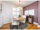 Dining room with hardwood floors, exposed brick, and a modern light fixture at 4310 Randolph Rd, Charlotte, NC 28211