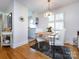 Bright dining area with stylish chandelier, table with four chairs, and hardwood floors at 4310 Randolph Rd, Charlotte, NC 28211