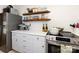 Bright kitchen with wooden shelves and stainless steel appliances at 4310 Randolph Rd, Charlotte, NC 28211