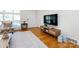 Bright living room with wood floors, a large TV, and comfortable seating near the window at 4310 Randolph Rd, Charlotte, NC 28211
