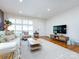 Inviting living room with natural light, hardwood floors, comfortable seating, and a TV at 4310 Randolph Rd, Charlotte, NC 28211