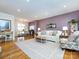 Spacious living room featuring hardwood floors, a brick accent wall, and comfortable seating at 4310 Randolph Rd, Charlotte, NC 28211