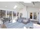 Bright sunroom features large windows, skylights, brick accent wall, and comfortable seating area with a patterned blue area rug at 4317 Sequoia Red Ln, Charlotte, NC 28226