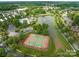 Aerial view of a community with lush green landscaping, a pond, a pool and tennis courts at 503 Georgetown Nw Dr, Concord, NC 28027