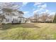 A lush green backyard extends from the house and deck and onto neighboring properties at 503 Georgetown Nw Dr, Concord, NC 28027